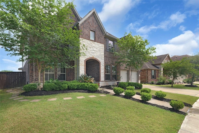 9615 Carson Ln, Iowa Colony, TX 77583 - view of front facade with stone siding, concrete driveway, and brick siding