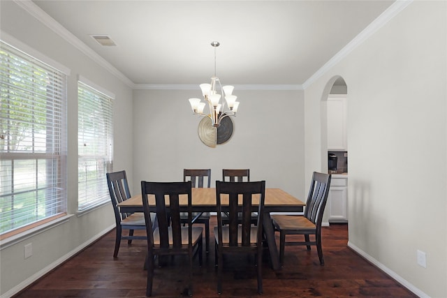 9615 Carson Ln, Iowa Colony, TX 77583 - dining room with a chandelier, ornamental molding, dark wood finished floors, baseboards, and arched walkways