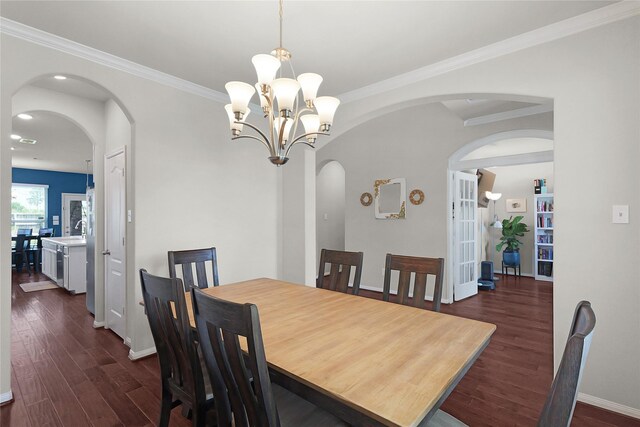 9615 Carson Ln, Iowa Colony, TX 77583 - dining space with dark wood-style flooring, arched walkways, baseboards, crown molding, and recessed lighting