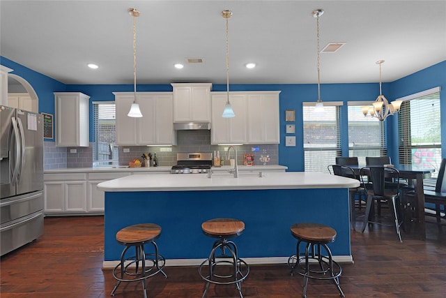 9615 Carson Ln, Iowa Colony, TX 77583 - kitchen with stainless steel appliances, a sink, light countertops, a kitchen breakfast bar, and backsplash
