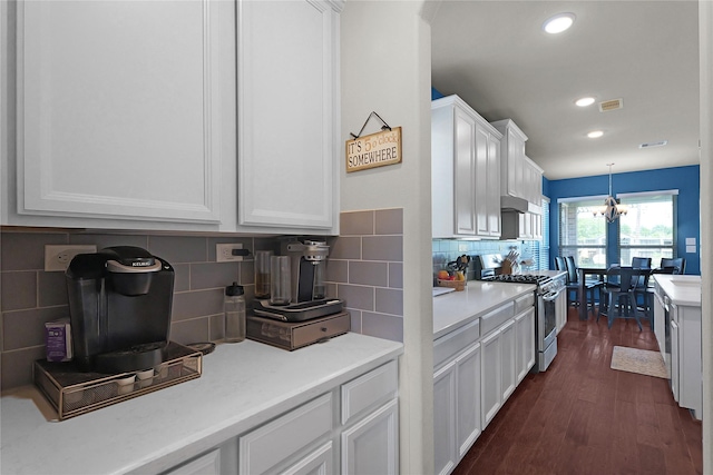 9615 Carson Ln, Iowa Colony, TX 77583 - kitchen with stainless steel range with gas cooktop, white cabinets, light countertops, dark wood finished floors, and tasteful backsplash