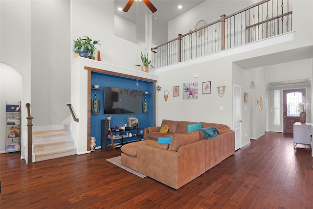 9615 Carson Ln, Iowa Colony, TX 77583 - living area with arched walkways, a towering ceiling, ceiling fan, stairs, and hardwood / wood-style floors