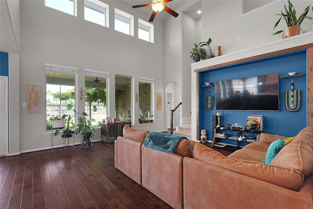 9615 Carson Ln, Iowa Colony, TX 77583 - living area featuring a high ceiling, ceiling fan, hardwood / wood-style flooring, stairs, and arched walkways