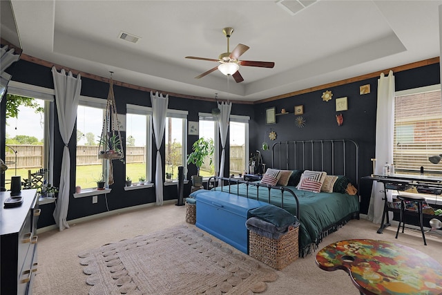 9615 Carson Ln, Iowa Colony, TX 77583 - bedroom with a tray ceiling, carpet flooring, access to outside, and a ceiling fan