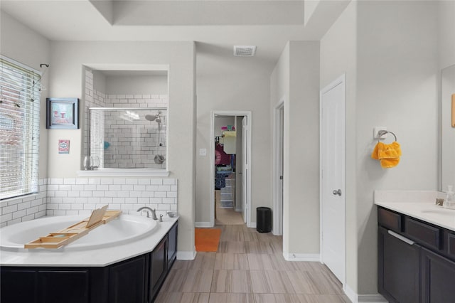 9615 Carson Ln, Iowa Colony, TX 77583 - full bathroom featuring a stall shower, a bath, baseboards, backsplash, and vanity