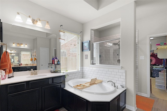 9615 Carson Ln, Iowa Colony, TX 77583 - full bath featuring a shower stall, a garden tub, backsplash, and vanity