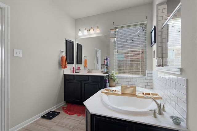 9615 Carson Ln, Iowa Colony, TX 77583 - full bathroom with a bath, vanity, and baseboards