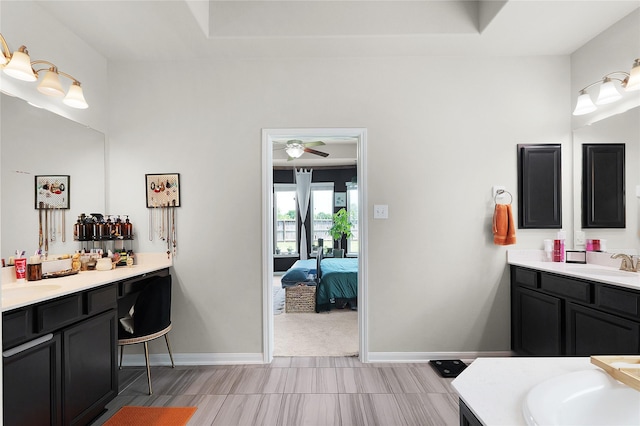 9615 Carson Ln, Iowa Colony, TX 77583 - full bathroom with two vanities, ceiling fan, baseboards, and connected bathroom