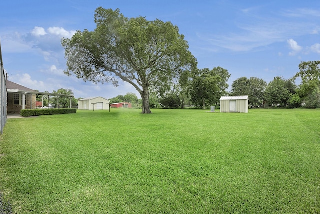view of green lawn featuring an outbuilding, a storage shed, and a detached garage