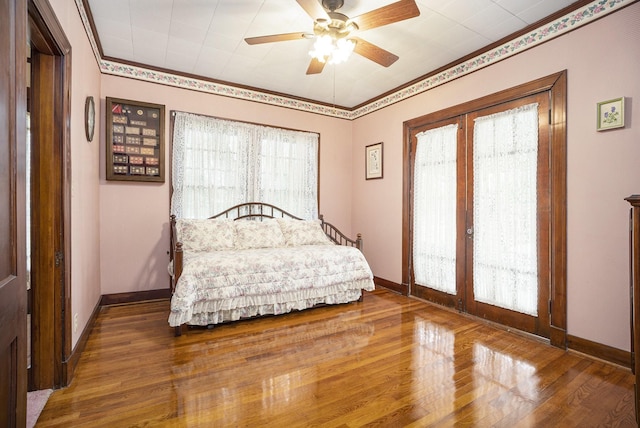 bedroom featuring french doors, wood finished floors, access to exterior, baseboards, and ceiling fan
