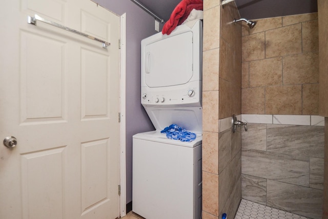 washroom featuring stacked washer and clothes dryer