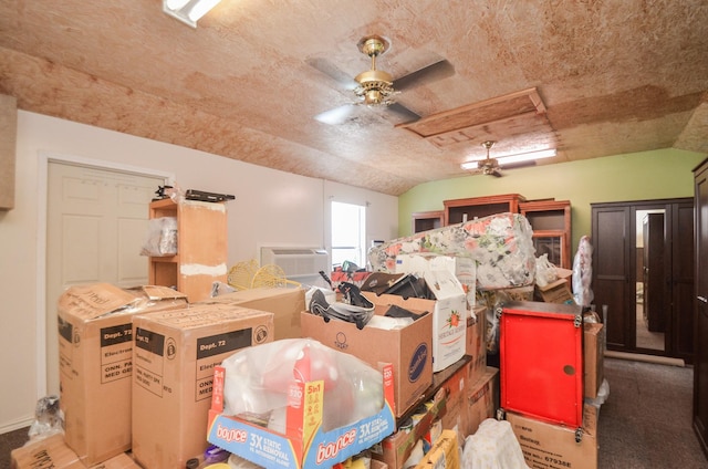 storage area with a ceiling fan and a wall mounted AC