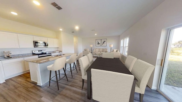 15311 Abella Dr, Montgomery, TX 77316 - dining space featuring wood finished floors and recessed lighting