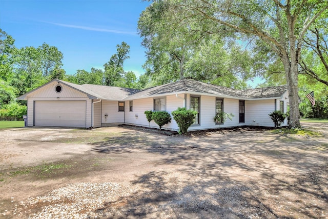 26410 Anderson Rd, Magnolia, TX 77354 - ranch-style house featuring dirt driveway and an attached garage