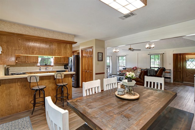 26410 Anderson Rd, Magnolia, TX 77354 - dining area with a chandelier and light wood-type flooring