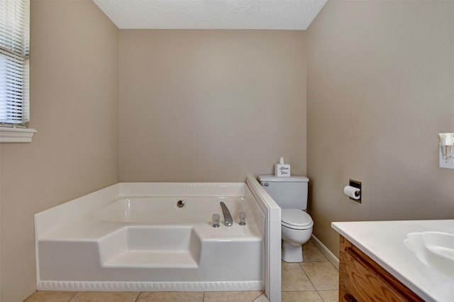 26410 Anderson Rd, Magnolia, TX 77354 - bathroom featuring toilet, a bath, vanity, and tile patterned floors
