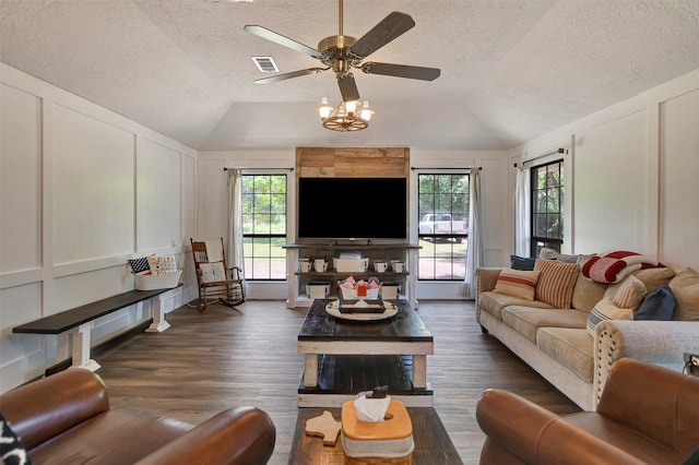26410 Anderson Rd, Magnolia, TX 77354 - living room featuring a decorative wall, vaulted ceiling, a textured ceiling, a ceiling fan, and dark wood-style floors