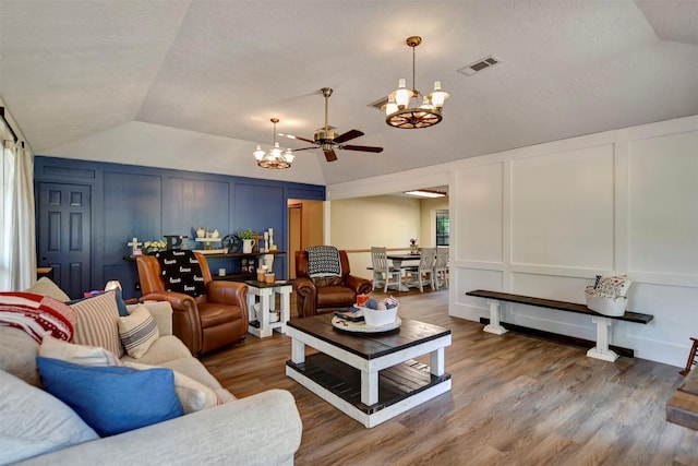 26410 Anderson Rd, Magnolia, TX 77354 - living area with a decorative wall, a chandelier, lofted ceiling, a ceiling fan, and wood finished floors