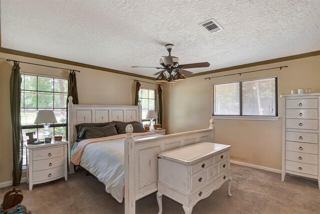 26410 Anderson Rd, Magnolia, TX 77354 - bedroom with crown molding, light colored carpet, ceiling fan, a textured ceiling, and baseboards