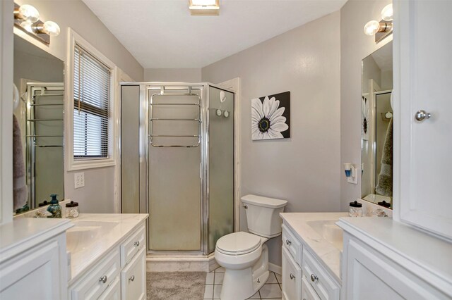 26410 Anderson Rd, Magnolia, TX 77354 - full bath featuring two vanities, a shower stall, tile patterned flooring, and toilet