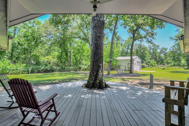26410 Anderson Rd, Magnolia, TX 77354 - wooden terrace with a lawn, an outdoor structure, and view of scattered trees