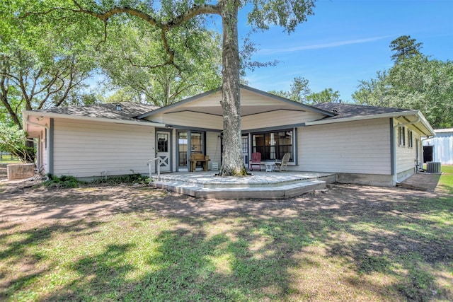 26410 Anderson Rd, Magnolia, TX 77354 - rear view of property featuring a yard, central air condition unit, and roof with shingles