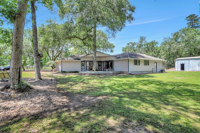 26410 Anderson Rd, Magnolia, TX 77354 - back of property featuring a yard and central AC