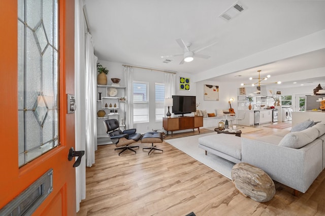 717 E 23rd St, Houston, TX 77008 - living area with light wood-style flooring, a ceiling fan, and washer / dryer