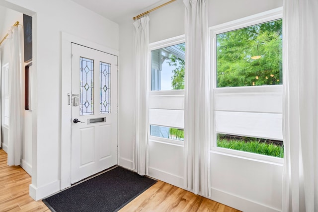 717 E 23rd St, Houston, TX 77008 - doorway to outside with light wood-style flooring, plenty of natural light, and baseboards