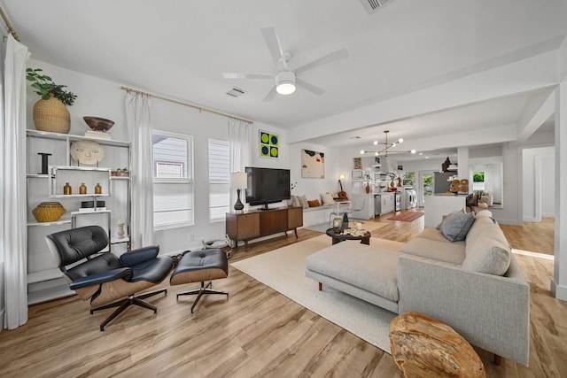 717 E 23rd St, Houston, TX 77008 - living area featuring light wood-type flooring, plenty of natural light, a ceiling fan, and a chandelier