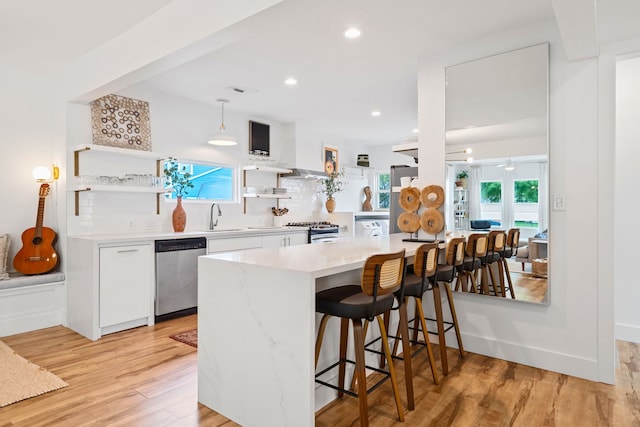 717 E 23rd St, Houston, TX 77008 - kitchen featuring appliances with stainless steel finishes, white cabinets, open shelves, a breakfast bar area, and light countertops