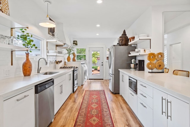 717 E 23rd St, Houston, TX 77008 - kitchen featuring open shelves, stainless steel appliances, a sink, backsplash, and washing machine and clothes dryer