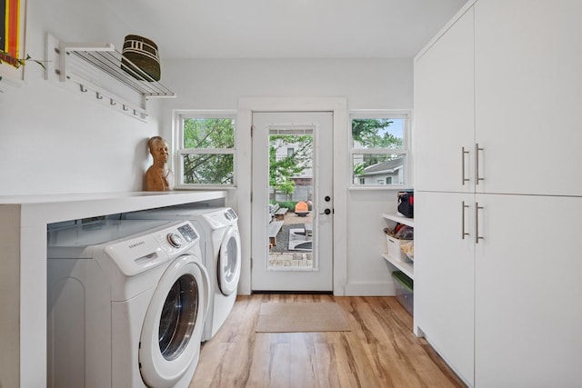 717 E 23rd St, Houston, TX 77008 - laundry room with cabinet space, washing machine and clothes dryer, and light wood-style floors