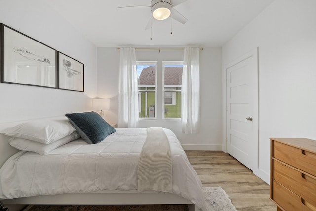 717 E 23rd St, Houston, TX 77008 - bedroom with light wood finished floors, a ceiling fan, and baseboards