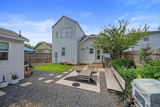 717 E 23rd St, Houston, TX 77008 - rear view of property with board and batten siding, a fenced backyard, and a patio