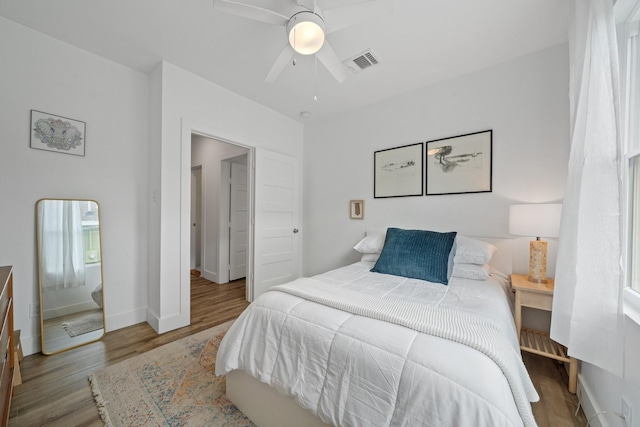 717 E 23rd St, Houston, TX 77008 - bedroom with wood finished floors, a ceiling fan, and baseboards