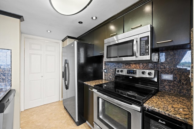 kitchen featuring stainless steel appliances, dark cabinets, tasteful backsplash, light tile patterned flooring, and recessed lighting