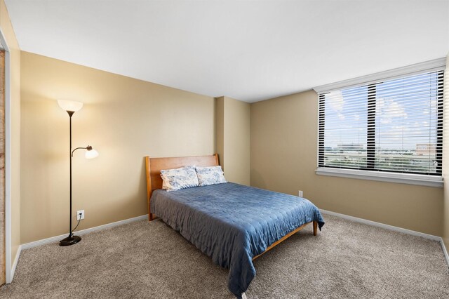 carpeted bedroom with baseboards