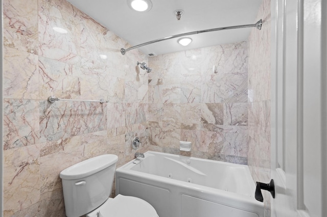full bathroom featuring toilet, shower / bathtub combination, and tile walls