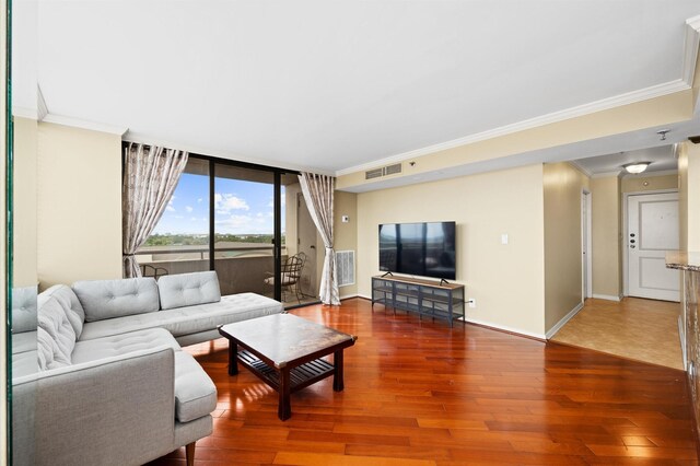 living room with crown molding, wood finished floors, floor to ceiling windows, and baseboards