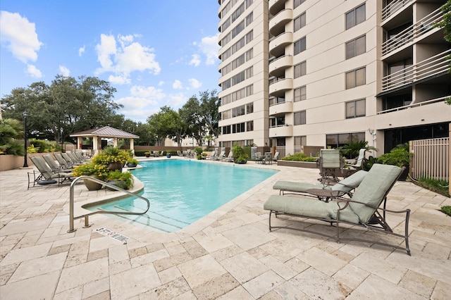 community pool featuring a gazebo and a patio