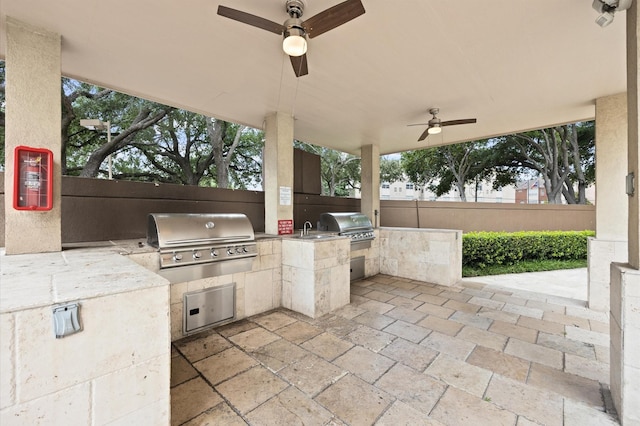 view of patio with grilling area, ceiling fan, and fence