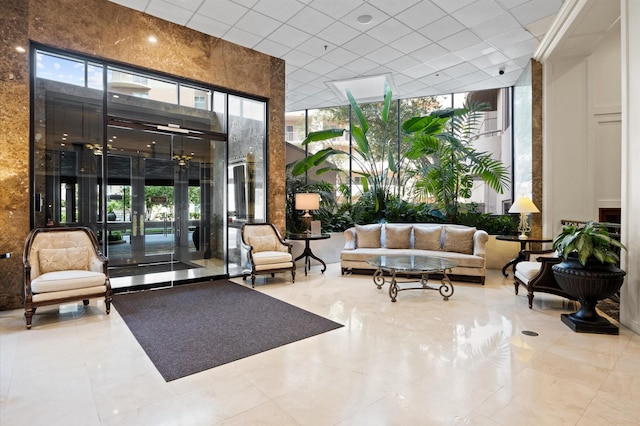 community lobby with floor to ceiling windows and a high ceiling