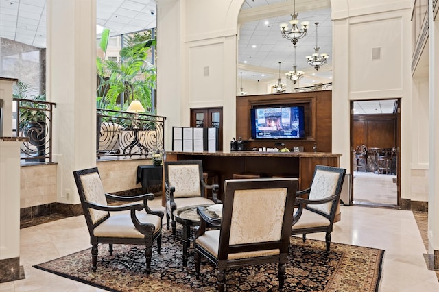 tiled dining room with a towering ceiling, a chandelier, recessed lighting, baseboards, and arched walkways