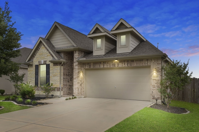 view of front of home with driveway, a shingled roof, stone siding, and brick siding