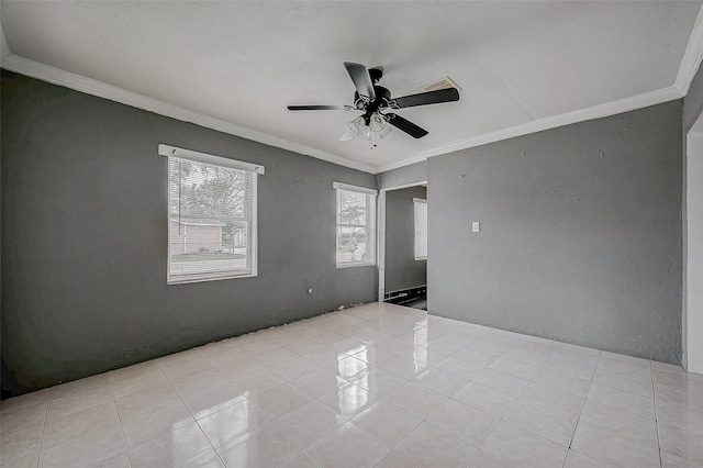 spare room with crown molding, light tile patterned floors, and ceiling fan