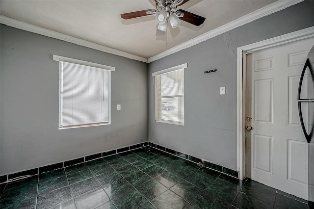 spare room with ceiling fan and crown molding