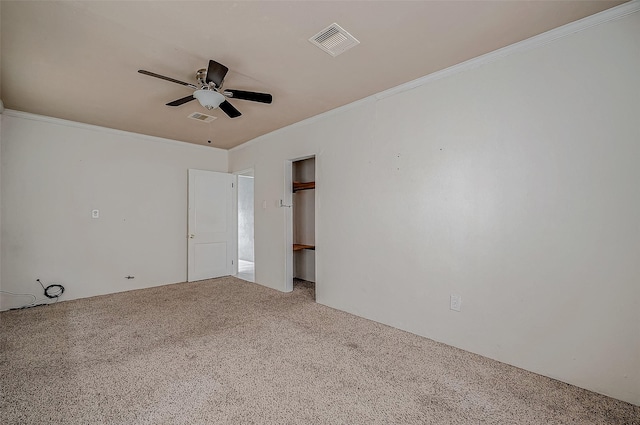 unfurnished room featuring carpet, a ceiling fan, and crown molding