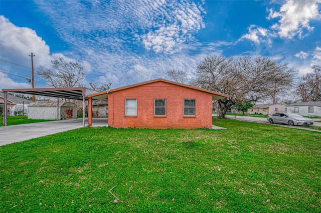 view of home's exterior featuring a carport, a yard, concrete driveway, and a shed
