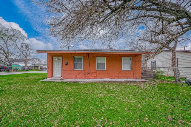 rear view of property featuring concrete block siding